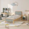 Children's bedroom with a bed, desk, and toys on a light-colored floor.