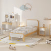 Children's bedroom with a wooden bed, desk, and toys on a light-colored floor.