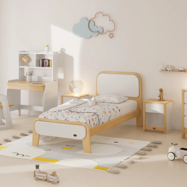 Children's bedroom with a wooden bed, desk, and toys on a light-colored floor.