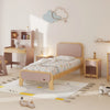 Children's bedroom with a bed, desk, and toys on a light-colored floor.