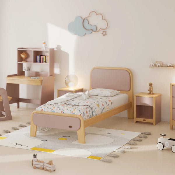 Children's bedroom with a bed, desk, and toys on a light-colored floor.
