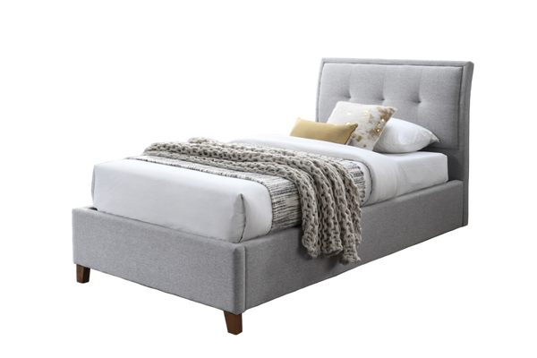 Light Grey king single size upholstered fabric bed with white bedding and decorative pillows in a modern bedroom.