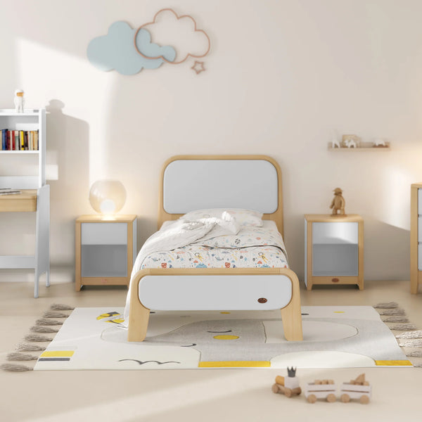 Children's bedroom with a bed, nightstands, and decorative items.
