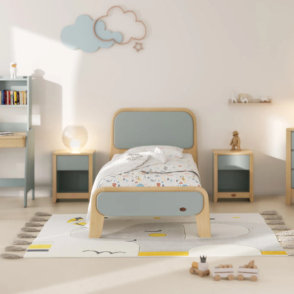 Children's bedroom with a bed, nightstands, and toys on a rug.