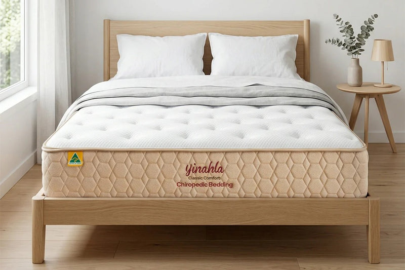 Yinahla Classic Comfort mattress studio product showcase on simple timber bedframe in a bedroom background