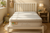 An Eco Kids Deluxe King SIngle Pillow Top Mattress pictured on a white timber bed frame with a slatted bedhead in a child bedroom setting with a teddy bear on a timber bedside table and a toy giraffe in a basket