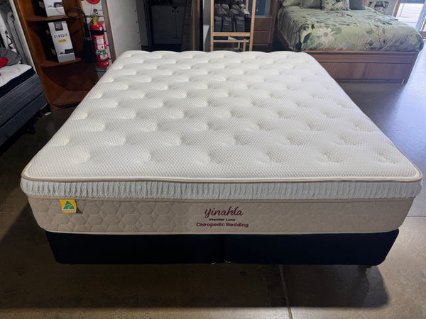 Mattress with brand logo on a partially visible background