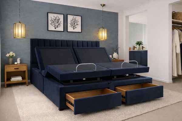 Navy blue adjustable bed with open drawers in a room setting.