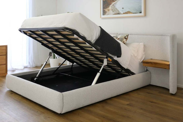 Light Grey fabric gas lift bed in a room with wooden flooring and a window.