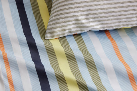 Inspired by lazy days spent seaside, our Halston Quilt Cover Set is reminiscent of awning-striped deck chairs and beach umbrellas. A versatile colour palette with summery shades throughout, it lends itself to versatile styling. For twice the fun — and the styling — the reverse features a horizontal stripe in a neutral colourway. Printed onto cotton sateen.