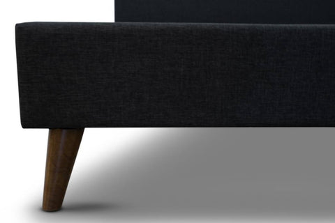 sleek tufted headboard upholstered in premium polyester fabric and dark chocolate legs.