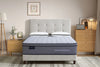 Morrison Good Morning mattress with quilted pillow-top and signature grey panel, styled in a warm contemporary bedroom with tufted linen bedhead, white pillows, timber dresser and floor lamp