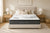 Morrison Signature Dream mattress with quilted pillow-top, styled in a sun-dappled bedroom with neutral pillows, oak bedside tables and a woven rug