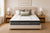 Morrison Signature Siesta mattress with quilted pillow-top, styled in a relaxed contemporary bedroom with linen bedding, ceramic lamps and rattan storage baskets