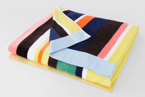 Jump into summer with the Sheridan Sunside Beach Towel! Perfect for a day at the beach, this unique towel has a vintage-inspired stripe pattern, plush velour front and absorbent terry reverse crafted from cotton. Get ready to soak u